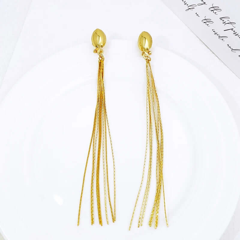 Golden Cascade Long Tassel Earrings – 18K Gold-Plated Statement Drop Earrings for Women | FancyDaria Jewelry on plate