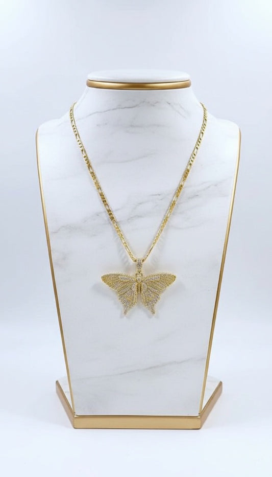 Gold butterfly pendant necklace on a marble stand with gold base