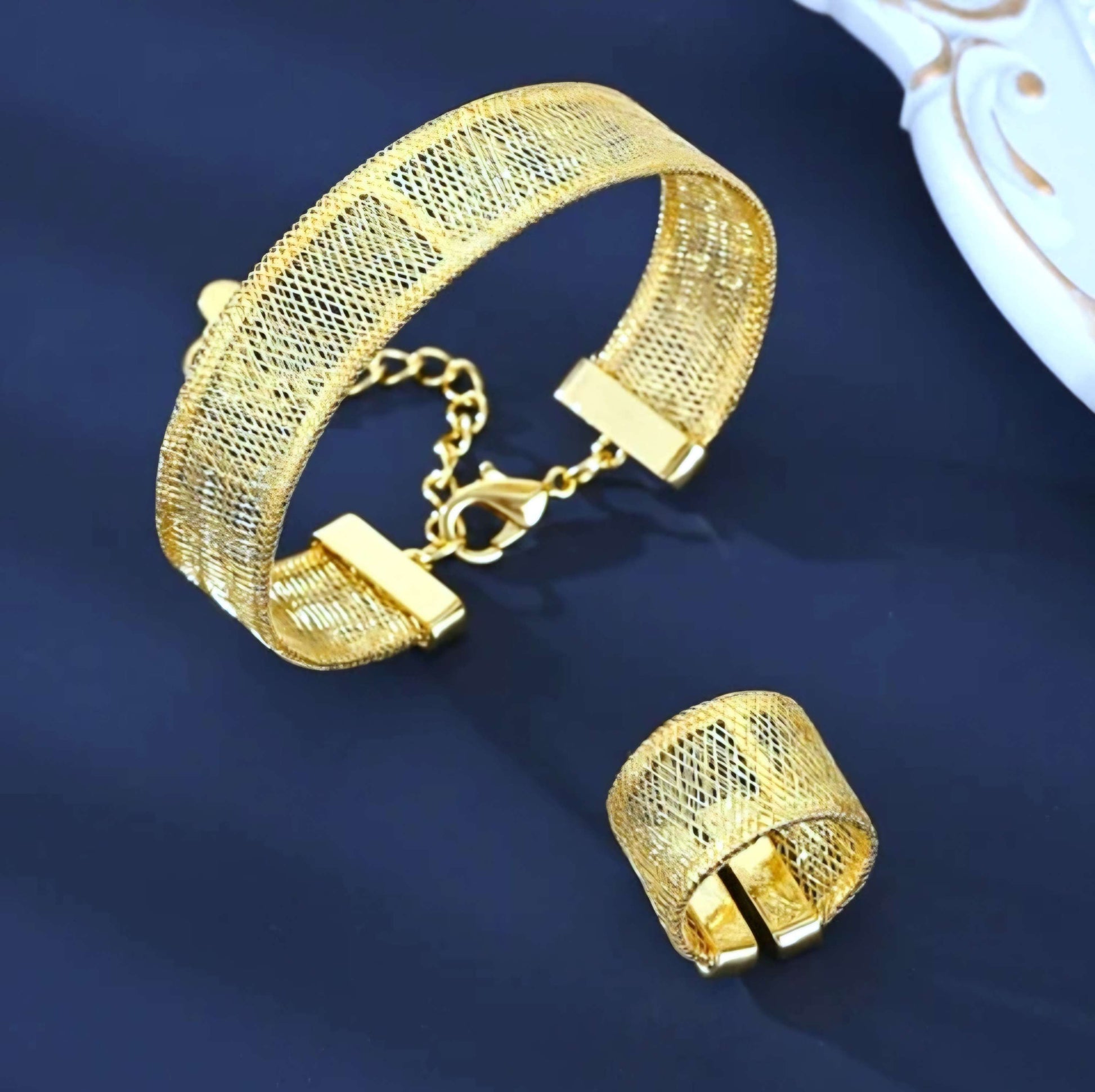 Gold mesh bracelet on a dark blue background