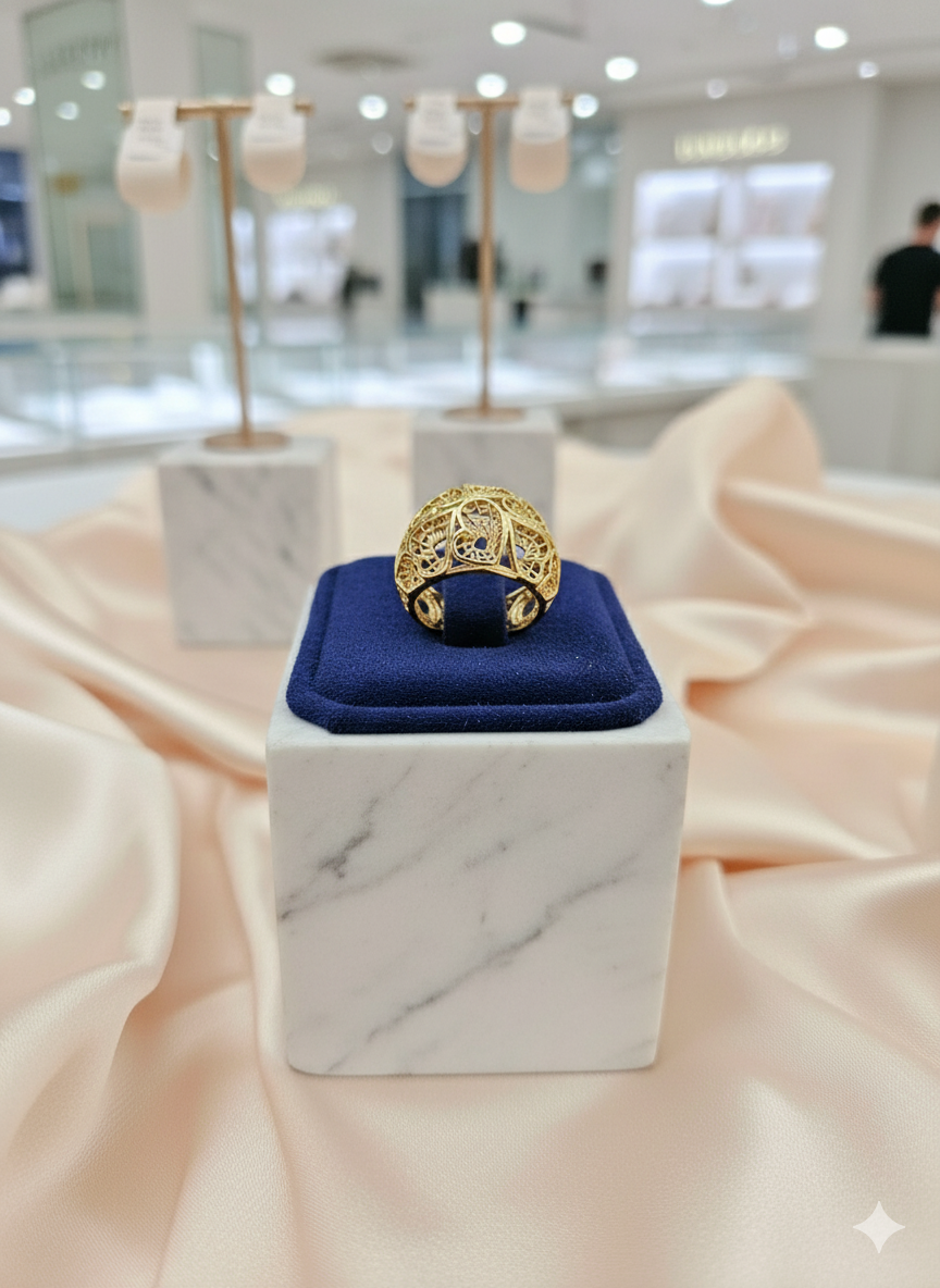 Gold ring on a blue cushion in a jewelry store setting