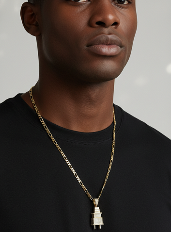Man wearing a black t-shirt with a gold chain and pendant against a gray background