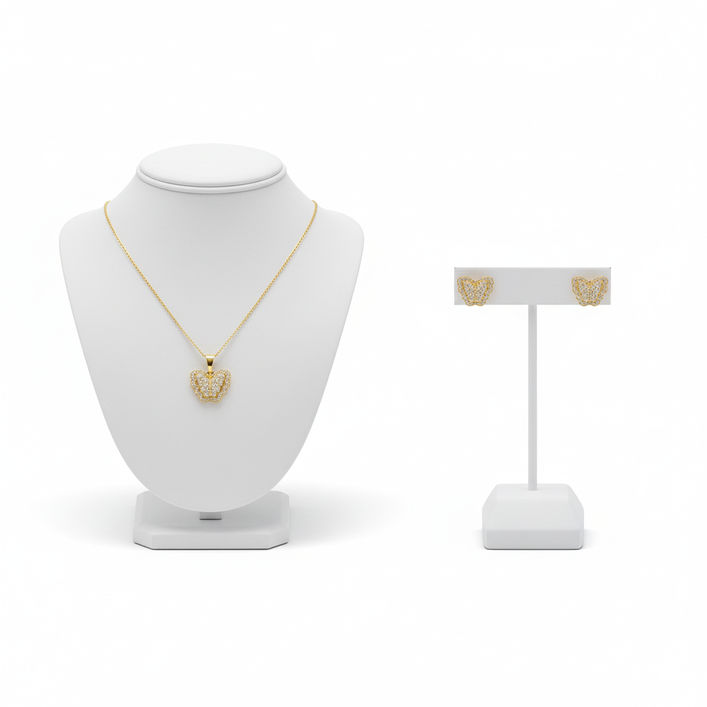 Gold necklace on a white mannequin bust with a matching earring on a stand against a white background