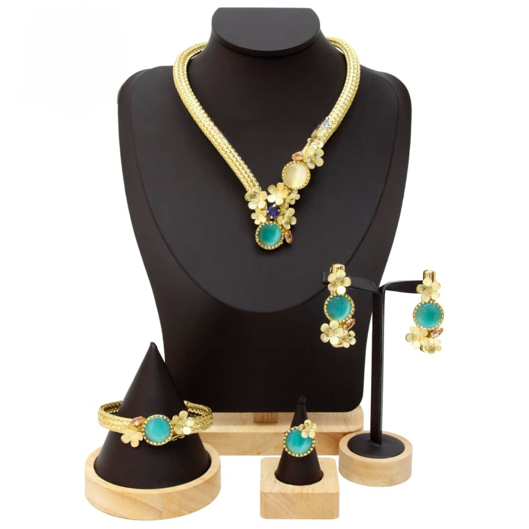 Jewelry set including necklace, earrings, and bracelet on a black mannequin bust.
