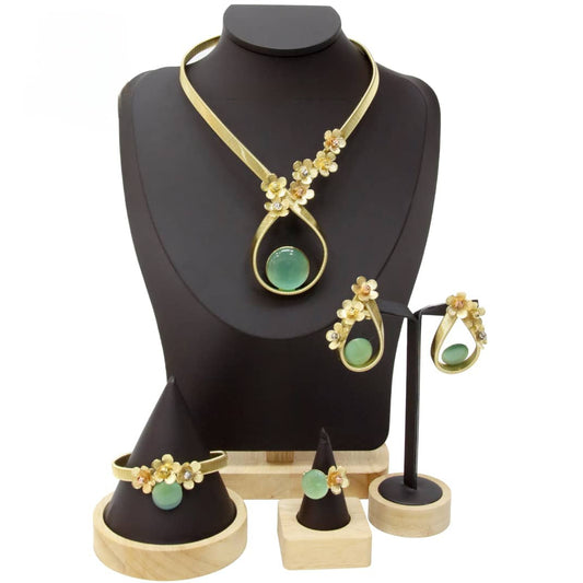 Jewelry set with necklace, earrings, and bracelet on a black mannequin bust.