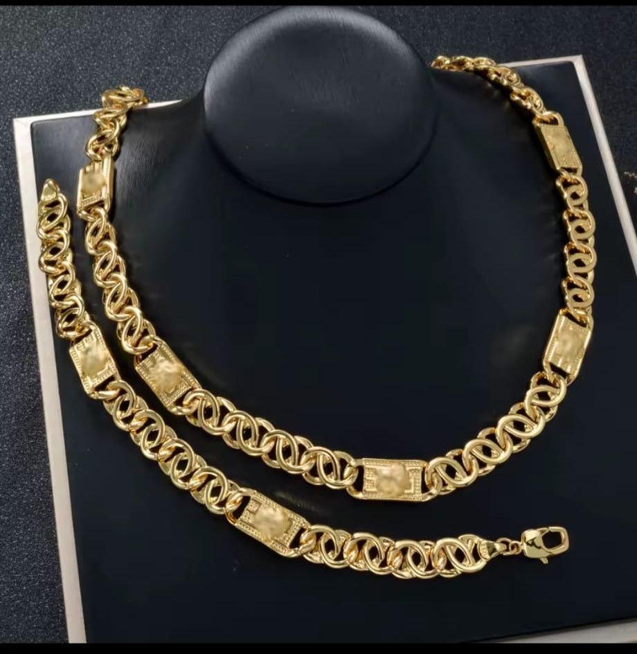 Gold chain necklace on a black stand