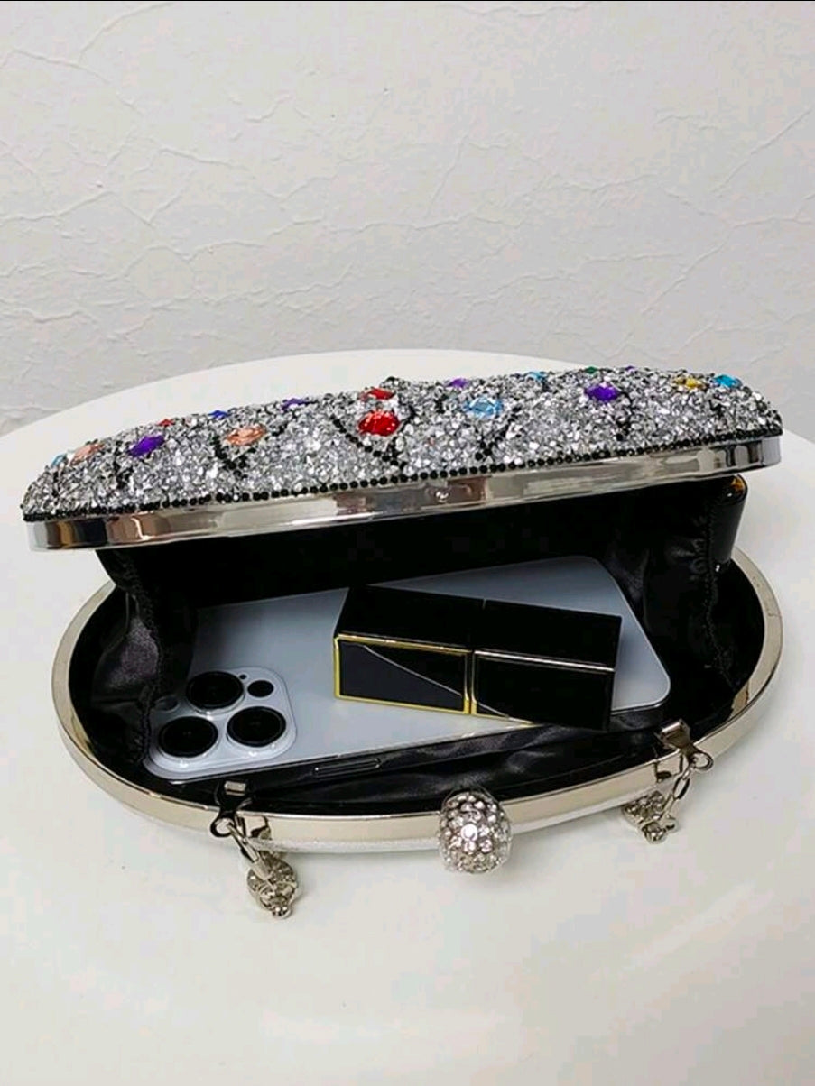 Decorative clutch with gemstones on a white background