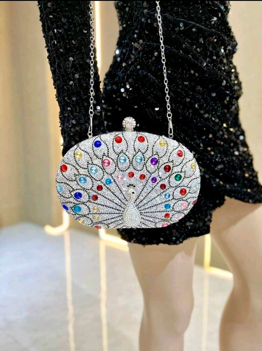 Elegant clutch bag with colorful gemstones on a black sequin dress.