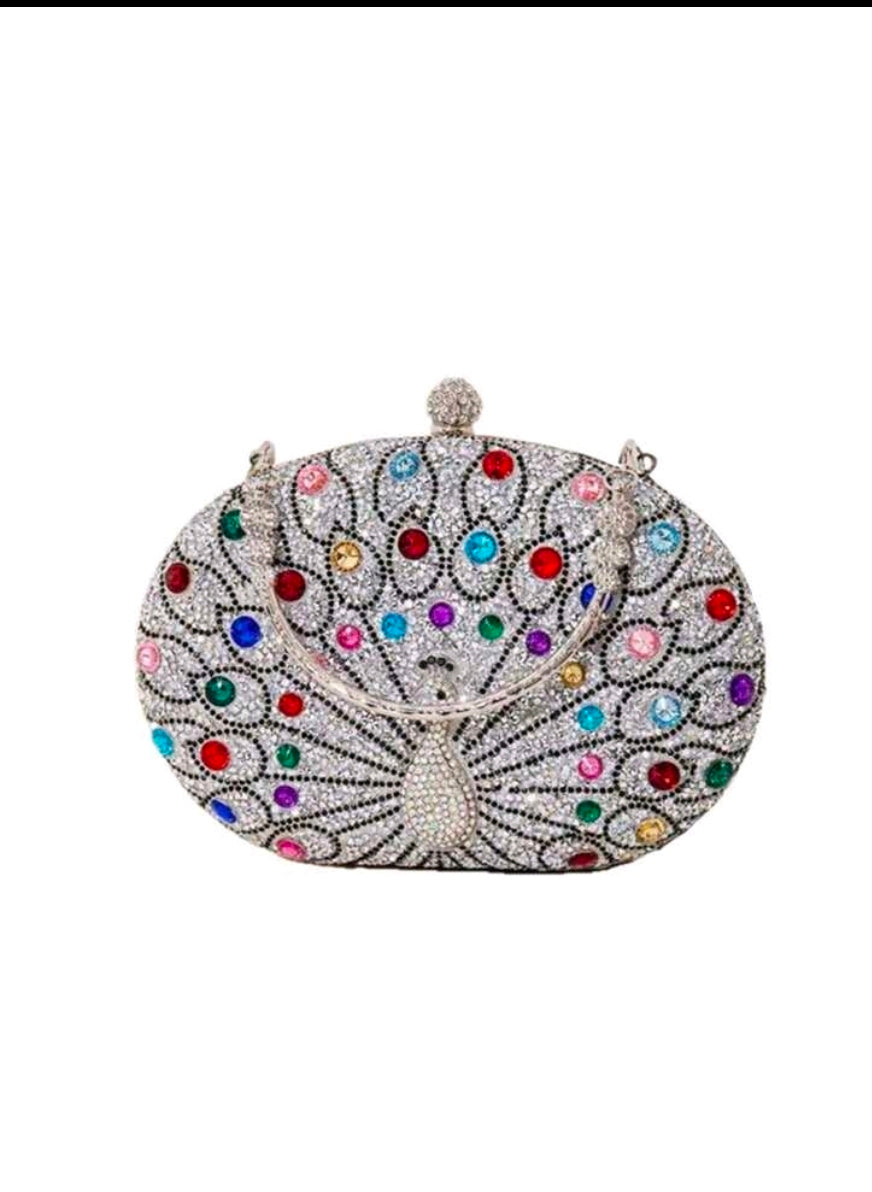 Decorative clutch bag with colorful gemstones on a white background
