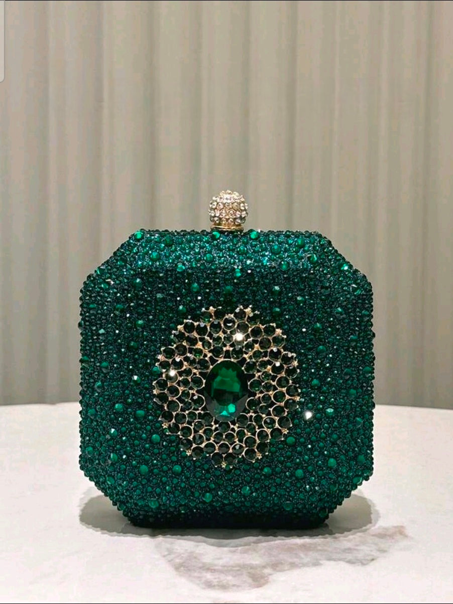 Green beaded clutch with intricate design on a neutral background