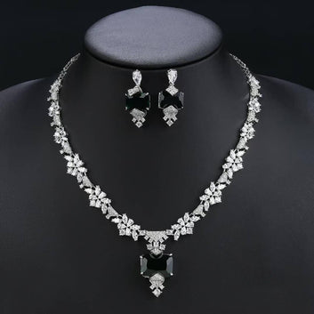 Jewelry set with necklace and earrings on a black mannequin against a dark background