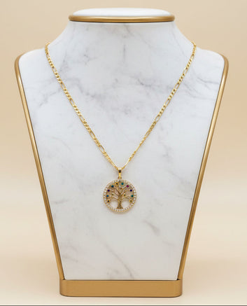 Gold necklace with a tree of life pendant on a black mannequin bust.