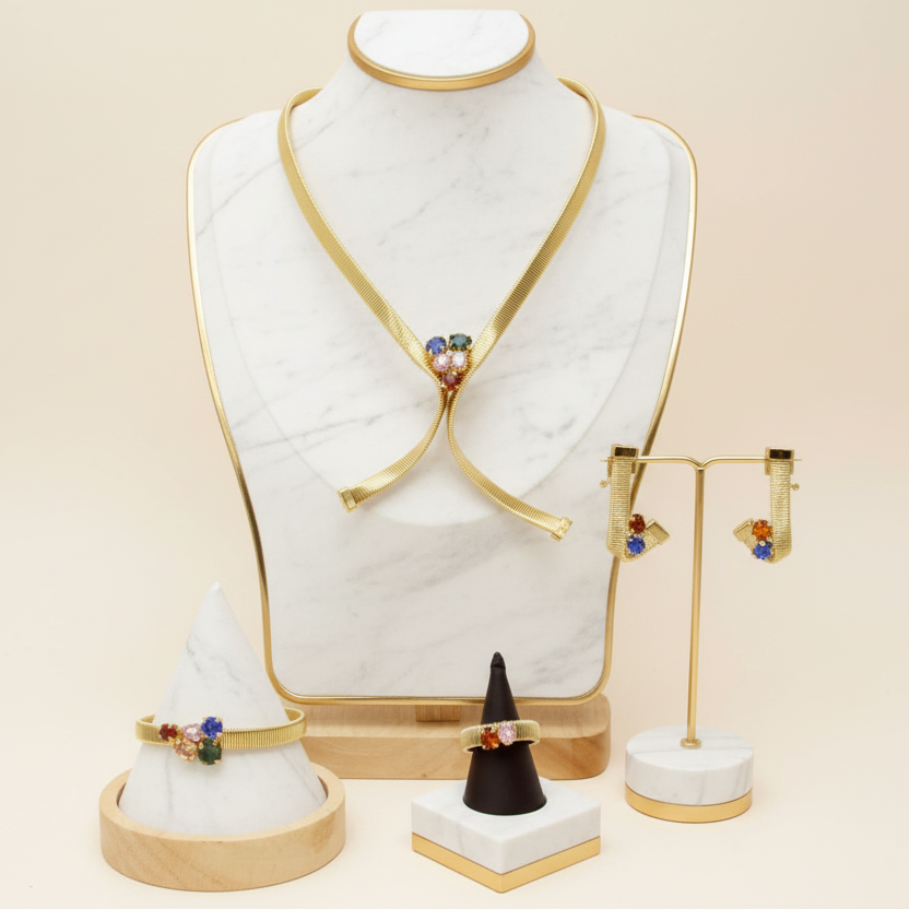 Jewelry set including earrings and a necklace on a mannequin bust with a beige background.