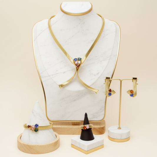 Jewelry set including earrings and a necklace on a mannequin bust with a beige background.