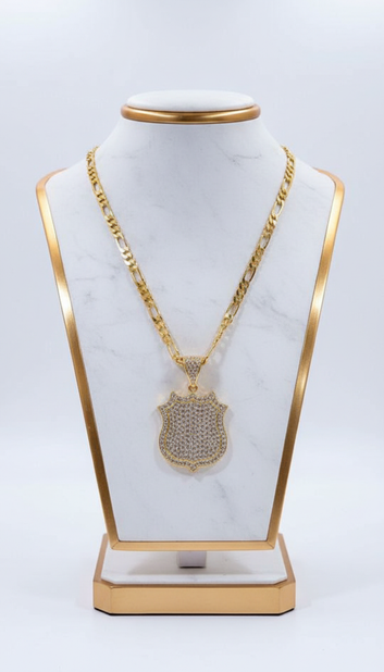 Gold necklace with a pendant on a white marble stand with gold frame