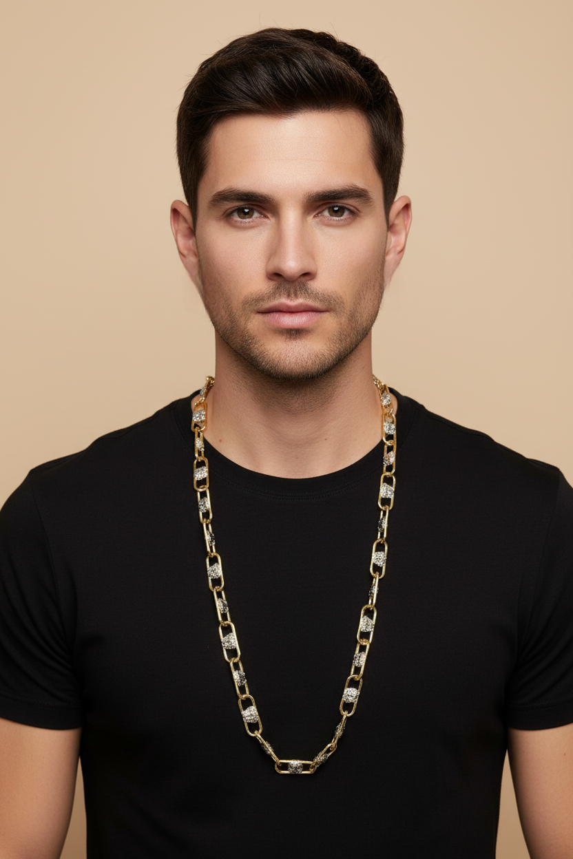 Man wearing a gold chain necklace against a beige background