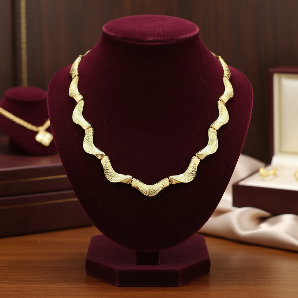 Gold necklace on a purple velvet stand with a blurred background