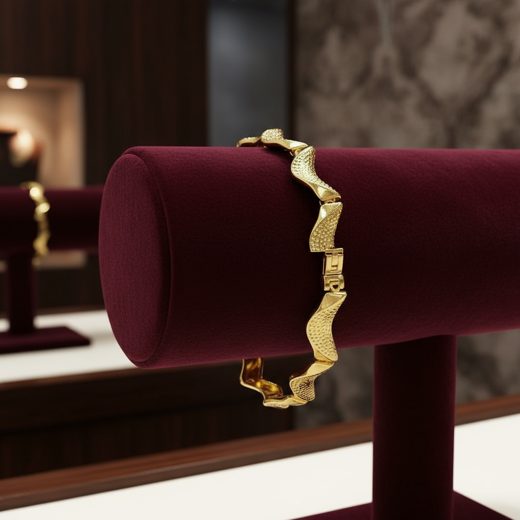 Gold bracelet on a red velvet stand with a blurred background