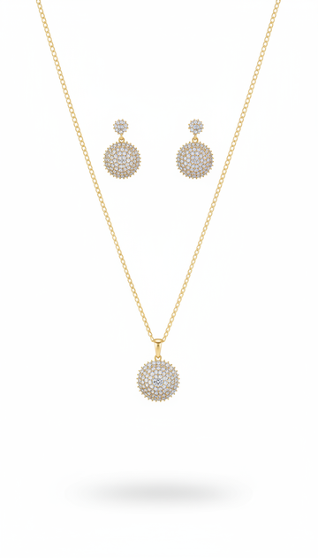 Gold necklace and earrings set on a white background