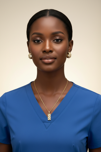 Woman wearing a blue top and gold necklace with a beige background
