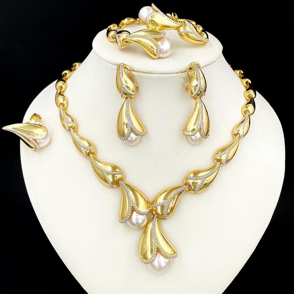 Gold and pearl jewelry set on a white stand