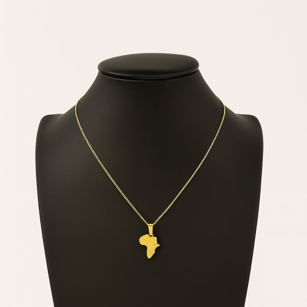 Gold necklace with a pendant shaped like the African continent on a black mannequin bust.