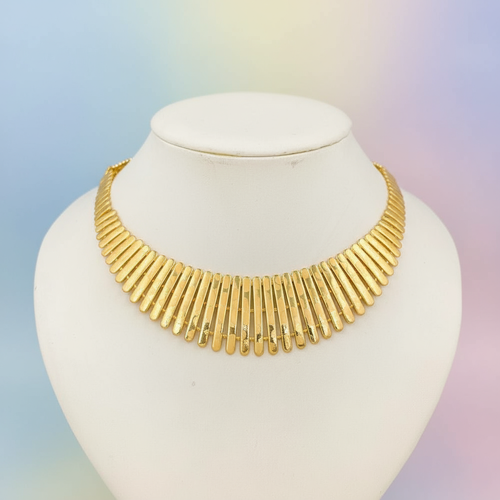 Gold necklace on a mannequin with a gradient background