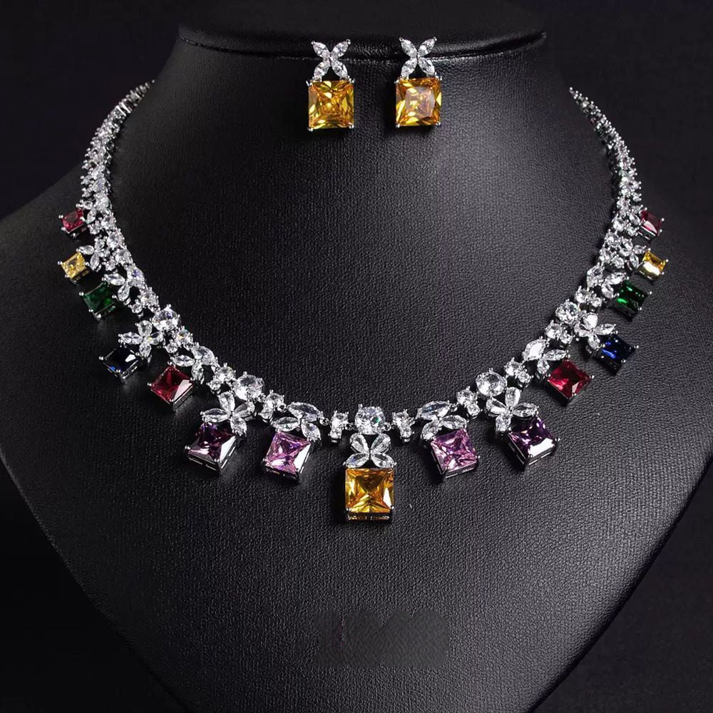 Multicolored gemstone necklace and earrings on a black mannequin