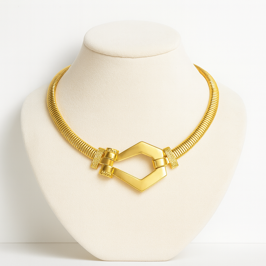 Gold necklace on a mannequin bust with a plain background