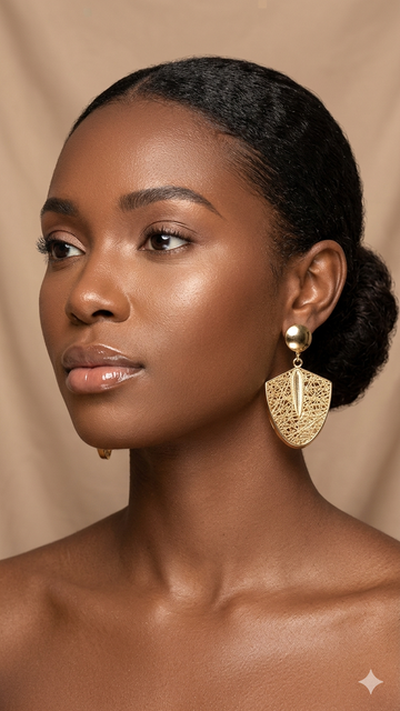 woman wearing gold filigree shield drop earrings with dome stud — fancy daria
