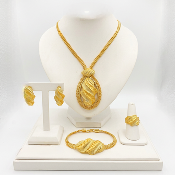 Gold jewelry set including necklace, bracelet, and ring on a white stand.