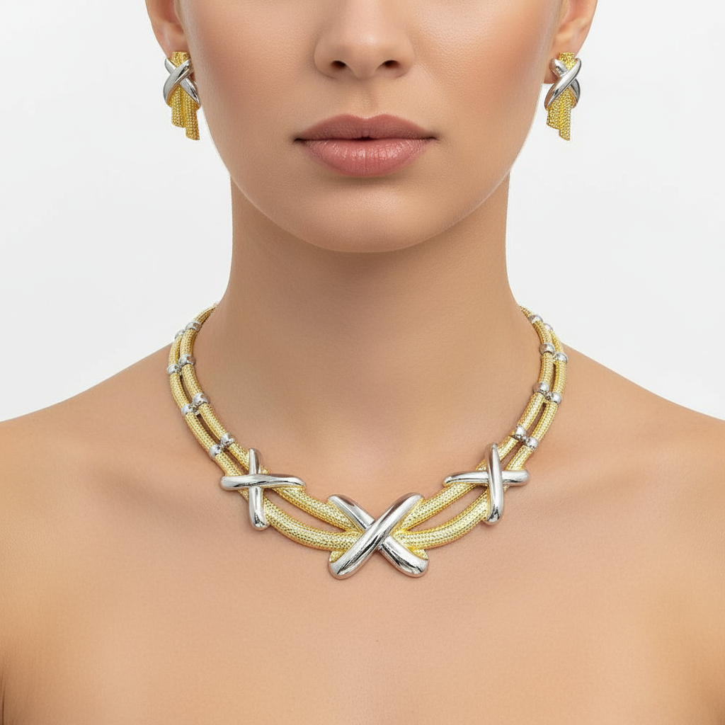 Necklace with silver 'X' designs on a model against a neutral background