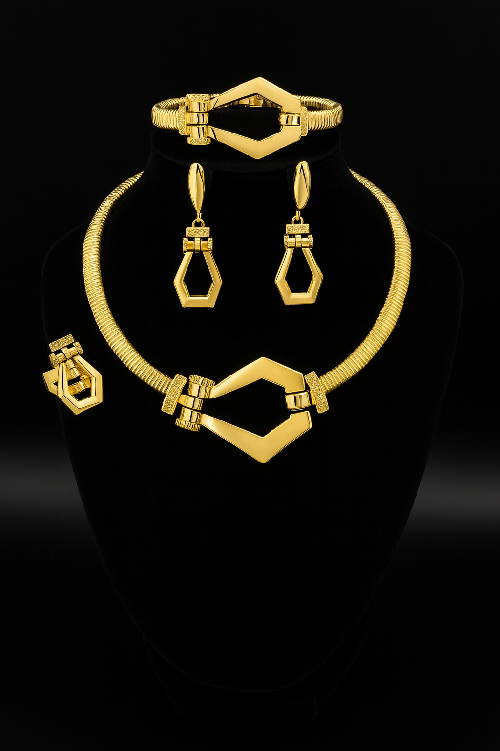 Adesewa Gold jewelry set including necklace, earrings, and bracelet on a black stand with black background